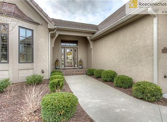 Beautifully Landscaped Entry to Spacious Brick Porch