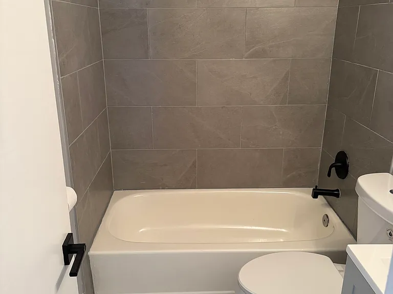 Tiled shower, and tub.
