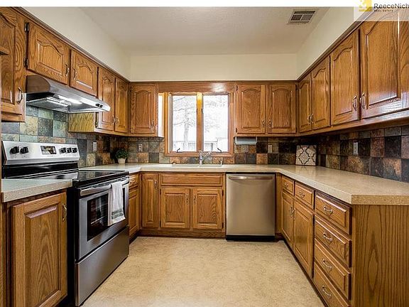 Kitchen with new dishwasher, new range, new hood, new lighting, new hardware.