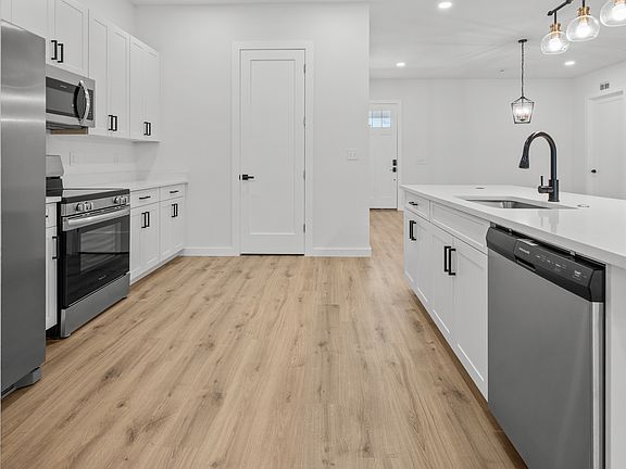 Updated modern kitchen with stainless steel appliances and pantry for extra storage a