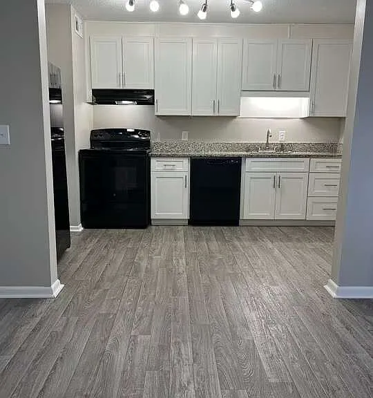 Check out the modern kitchen at Arbor Terrace, featuring sleek black appliances and stylish cabinetry. The open layout and abundant light create an inviting atmosphere, perfect for cooking and entertaining. Schedule your visit today!