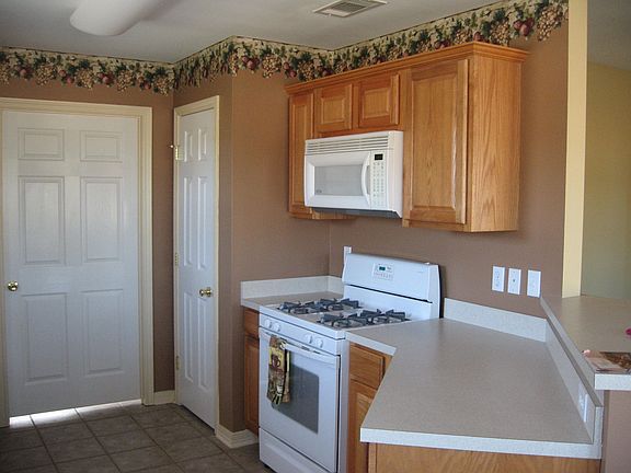 Kitchen with gas stove & large laundry room