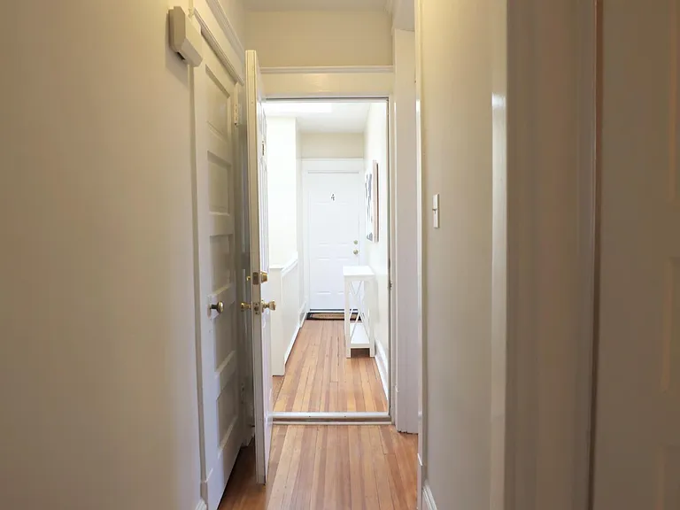 hallway showing the entry closet on left and looking out into the building hallway.