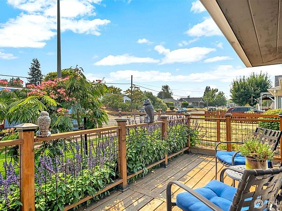 Comfortable front deck overlooking beautifully landscaped front yard.