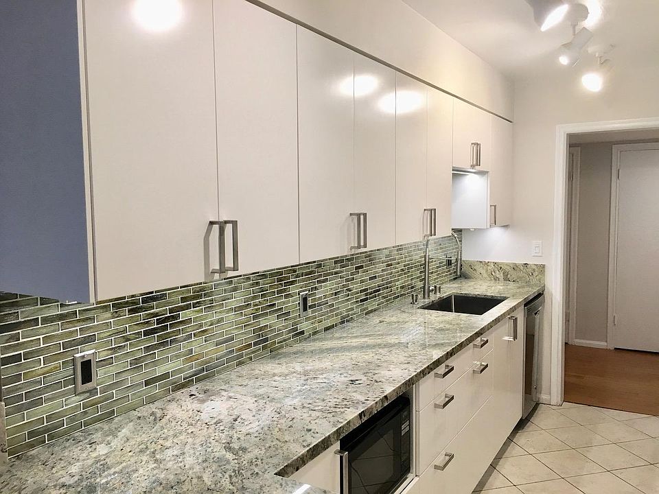 Newly remodeled kitchen with stainless steel appliances, under cabinet lighting, gas stove