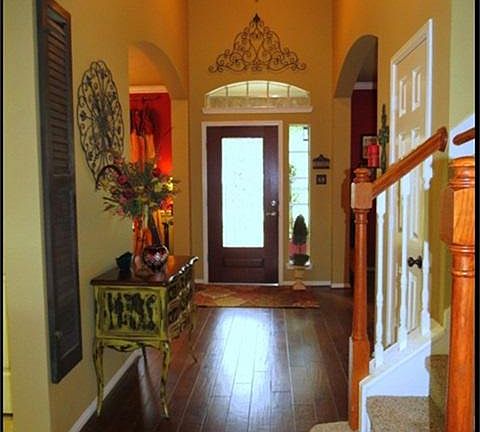 Entry has lead glass door, handscraped wood floors and custom paint.