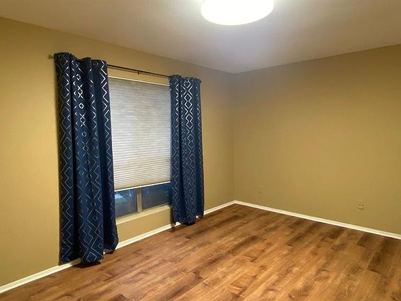 Bedroom to the left as you enter the home with laminate floors.
