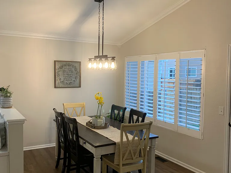 Large, open dining room area, with high ceilings and great window and blinds. Access to the backyard.