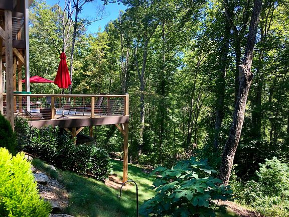 LOWER LEVEL DECK IS HIGH ENOUGH OFF THE GROUND TO STILL ENJOY THE BREEZES OF THE TREEHOUSE AND WOODED VIEWS IN MID-SUMMER!