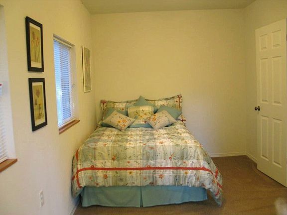 The warm, cozy bedroom says, â??Stay a while!â?? The perfect spot to ready, catch up on corresponden