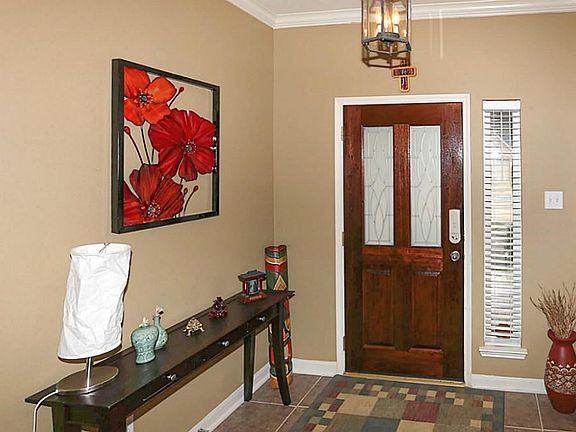 Front door entry with lead glass. Crown molding and tile floors.