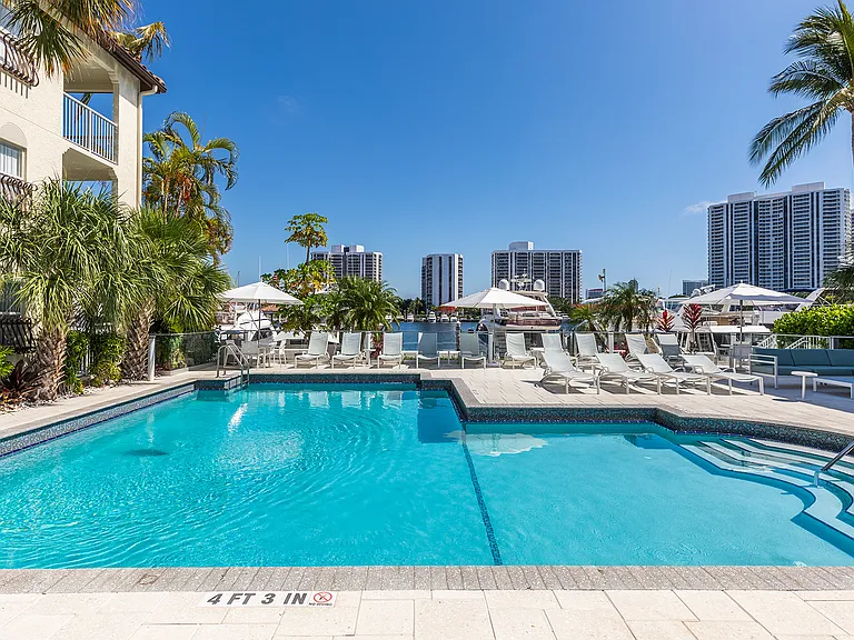 Outdoor, saltwater pool and sundeck overlooks the marina and views of the city