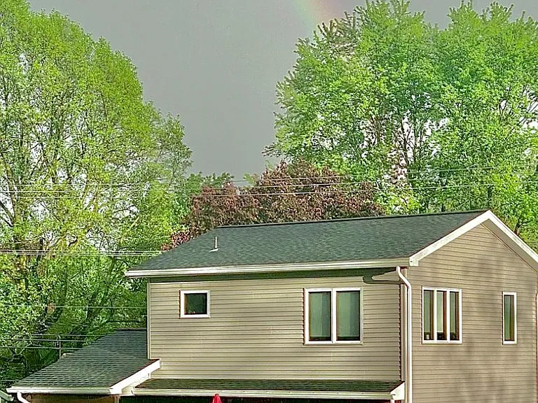 Back of House. Wooden fence on left side of backyard, and arborvitae row and along back of yard. This house is the Pot of Gold at the end of the Rainbow. You need to see to believe!