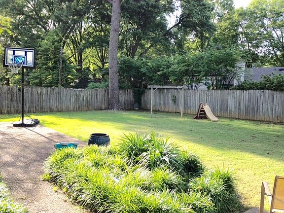 Fenced backyard for playing and a pet