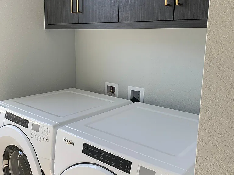 2nd floor Washer and Dryer with cabinets. Laundry room