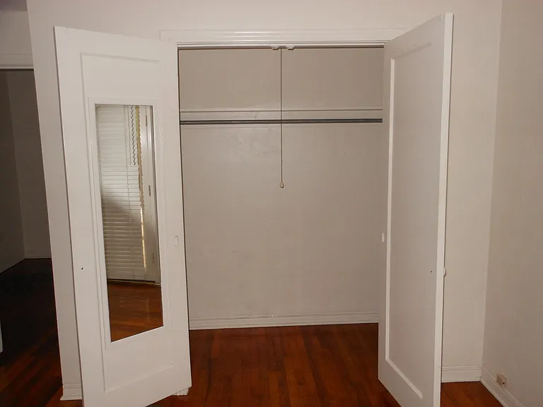 LARGE closet in bedroom, shelves above the bar and on one end of the closet