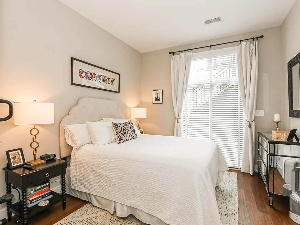 Primary bedroom with large windows and natural light