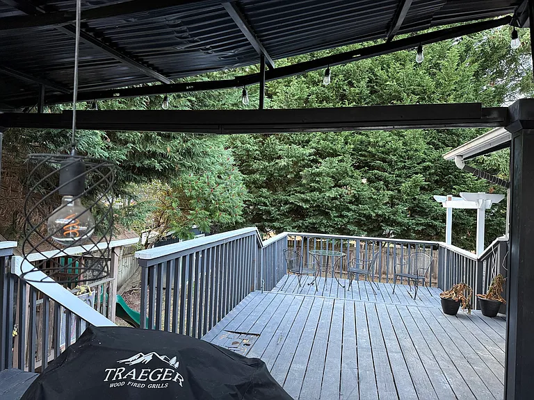Picture shows trees but those are removed and a new house under construction on other side of the deck