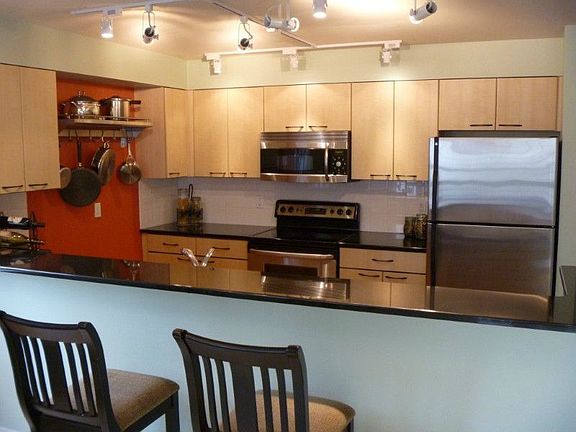 Awesome kitchen with eating bar, granite counters and stainless steel appliances.