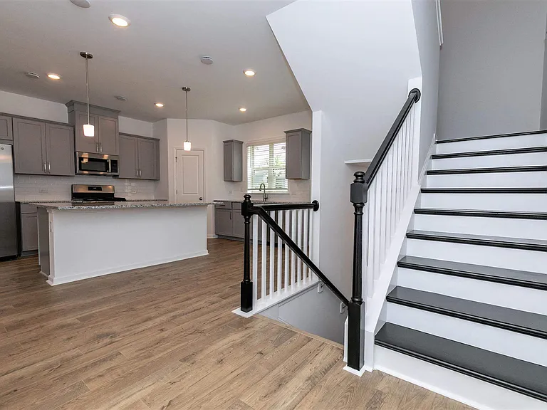 Spacious kitchen offering an elegant path to the stairwell.