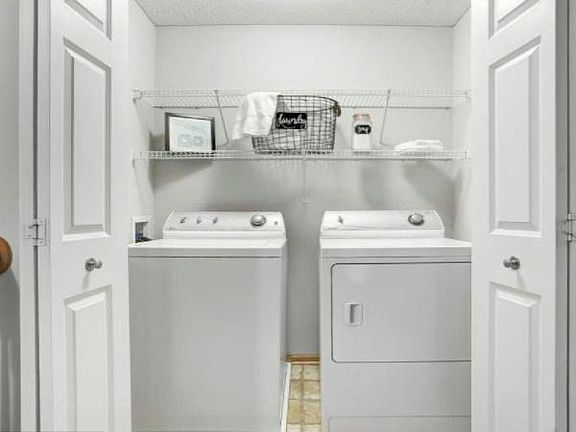 Upper level washer/dryer with racks for storage.