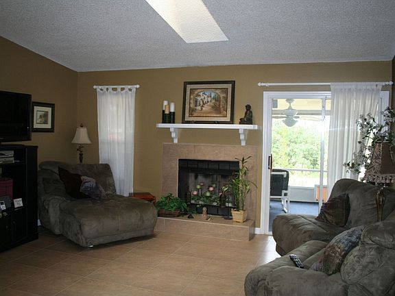 Cozy fireplace in the newly tiled (porcelin) family room.