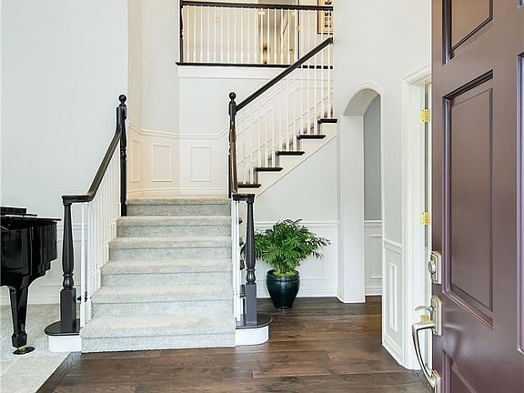 Impressive 2-story entry welcomes you into this stunning home saturated with high end finishes, custom details, and richly hued hardwoods. French doors just to the right leading to the office/den.