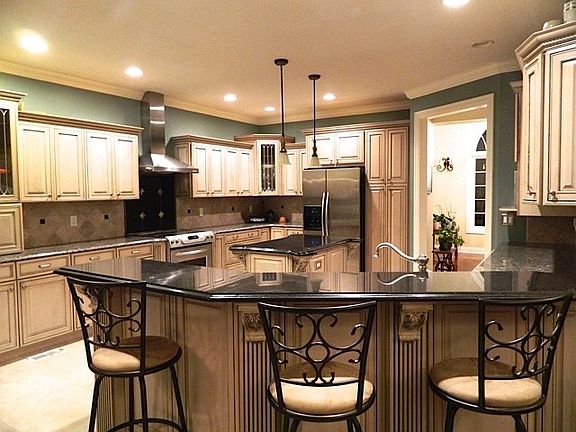 Granite countertops, center island , and custom cabinets.