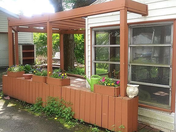 planter boxes, pergola, patio and garage. Enclosed patio has jalousie windows all around, and they work.
