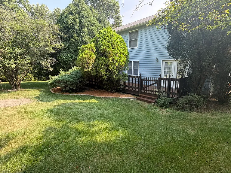 Rear view with just-cleaned and re-stained deck. We will be trimming the bushes too.,