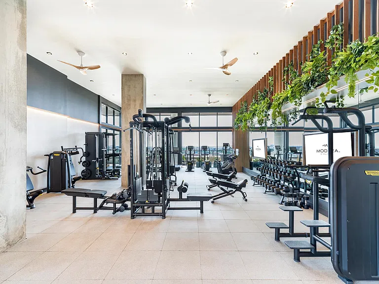 Stay active in the expansive fitness center at Modera St. Paul, offering cutting-edge equipment and inspiring views of downtown Dallas.