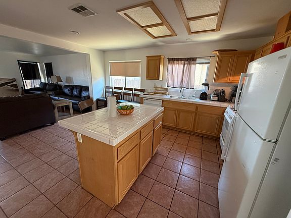 Open kitchen with eating area and spacious family room and fireplace. (Tenant in process of moving.)
