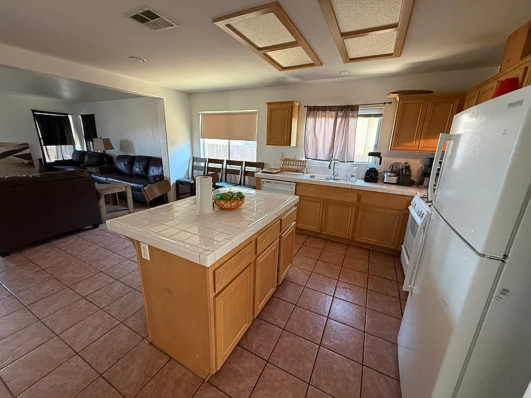 Open kitchen with eating area and spacious family room and fireplace. (Tenant in process of moving.)