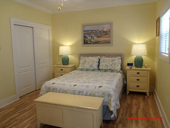 Queen bed with new sheets and quilt