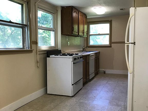 This kitchen has a dishwasher and room for a dining room table.