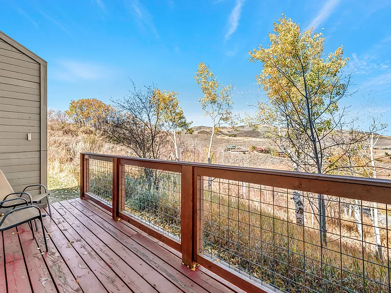 Back deck off living room with walk out access to grassy area