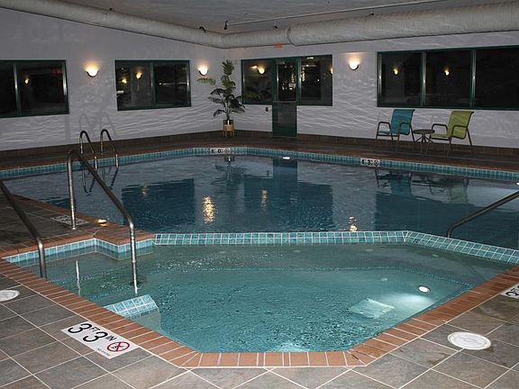 Indoor Heated Pool And Whirlpool, With An Exterior Outdoor Patio, With Gas Grills Included.