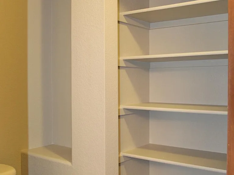 Private water closet has a huge linen closet