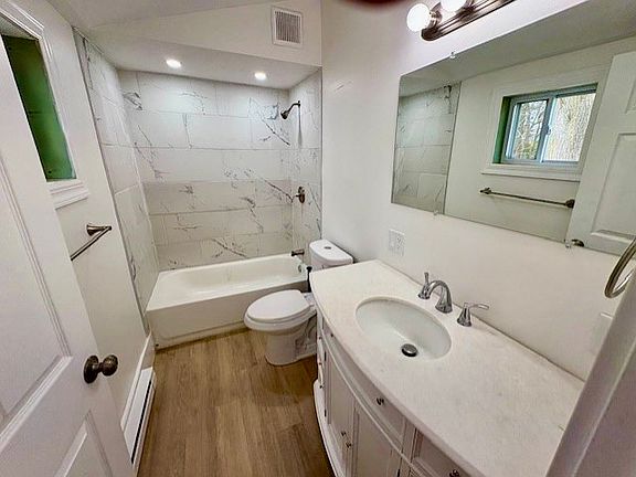 Tiled surround bathroom, with quartz top vanity.