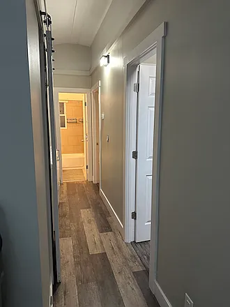 Hallway to bath, bedrooms and laundry area. There is an LG washer and dryer set in the space that is available for purchase.