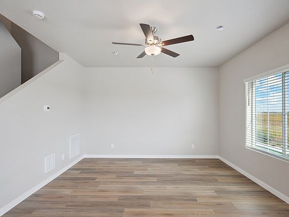 The family room is spacious with a ceiling fan.