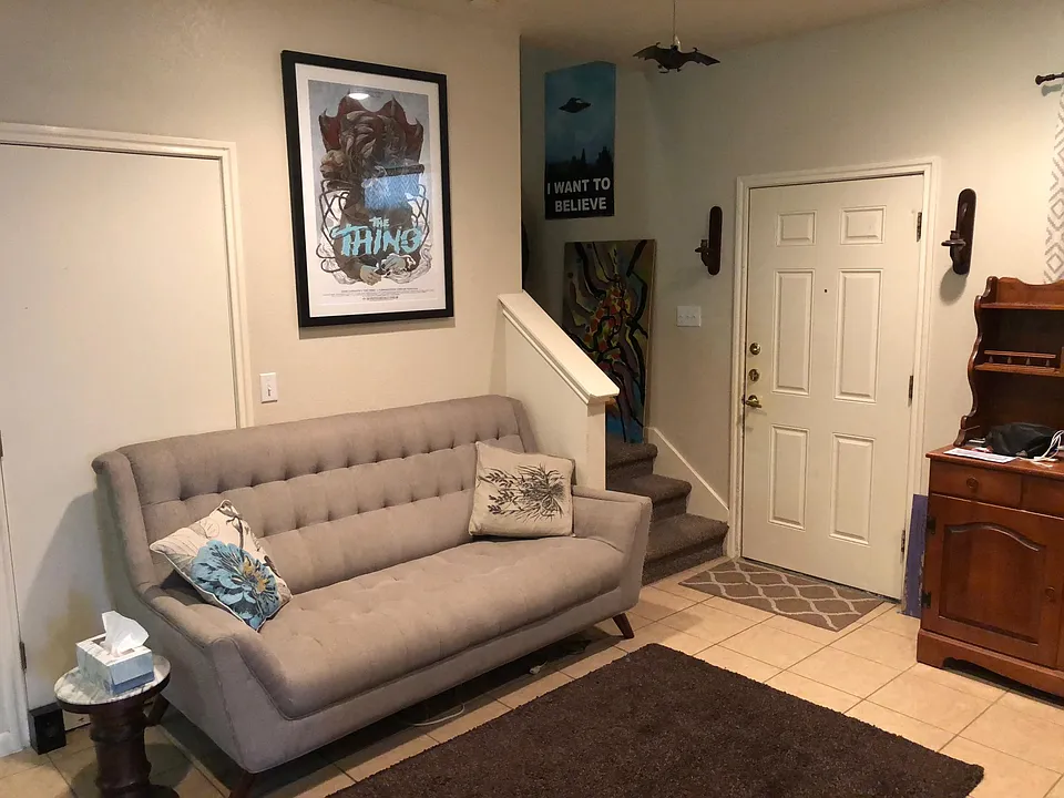 Living room with view of stairs to second level