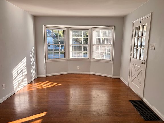 Living room, with hardwood floors, and bay window