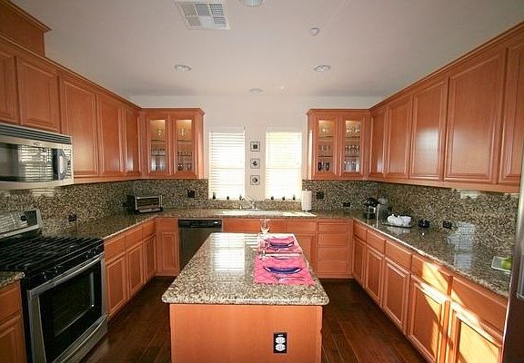 Tastefully upgraded kitchen island and birchwood cabinets