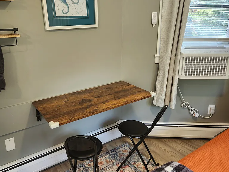 Bedroom 3 with queen bed on second floor, separate entrance, mini-fridge, mircowave, smart TV, fold away table and chairs, shower stall, bathroom sink, toilet, and views of backyard.