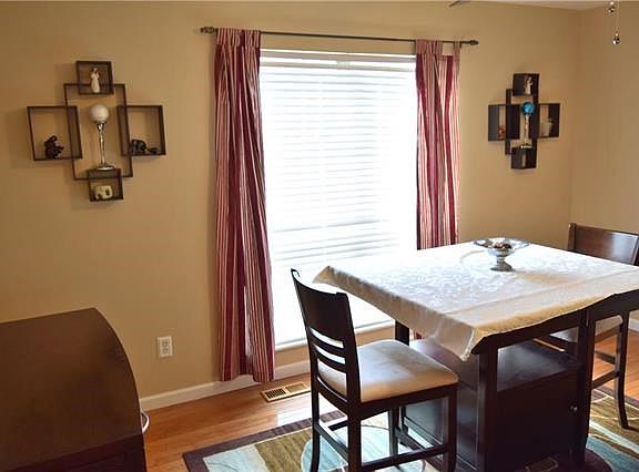 Dining room with a large picture window overlooking the back yard.
