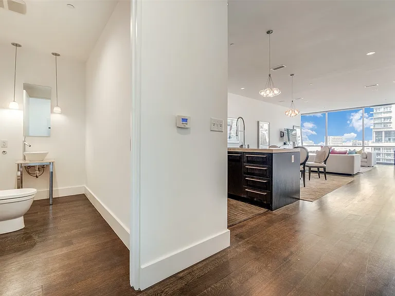 Hallway with expansive windows, dark wood-type flooring, recessed lighting, and a chandelier