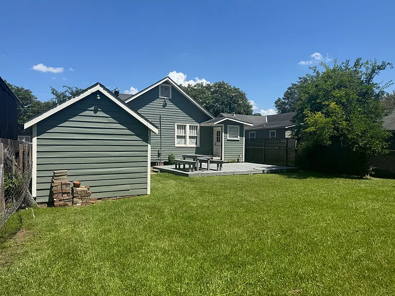 Backyard facing home, gated yard for dogs and kids to play