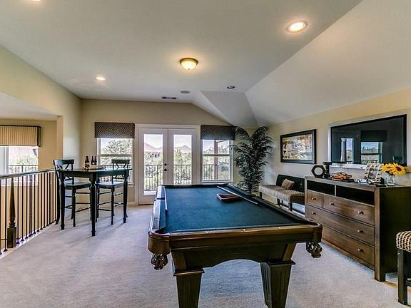 Game room on 2nd floor with door to balcony