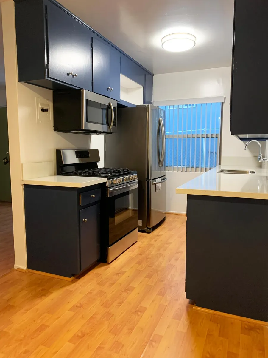 kitchen (ofc), with modern appliances (gas oven, microwave, double-door fridge and freezer, stainless steel sink). - 1230 N Fuller Ave #3